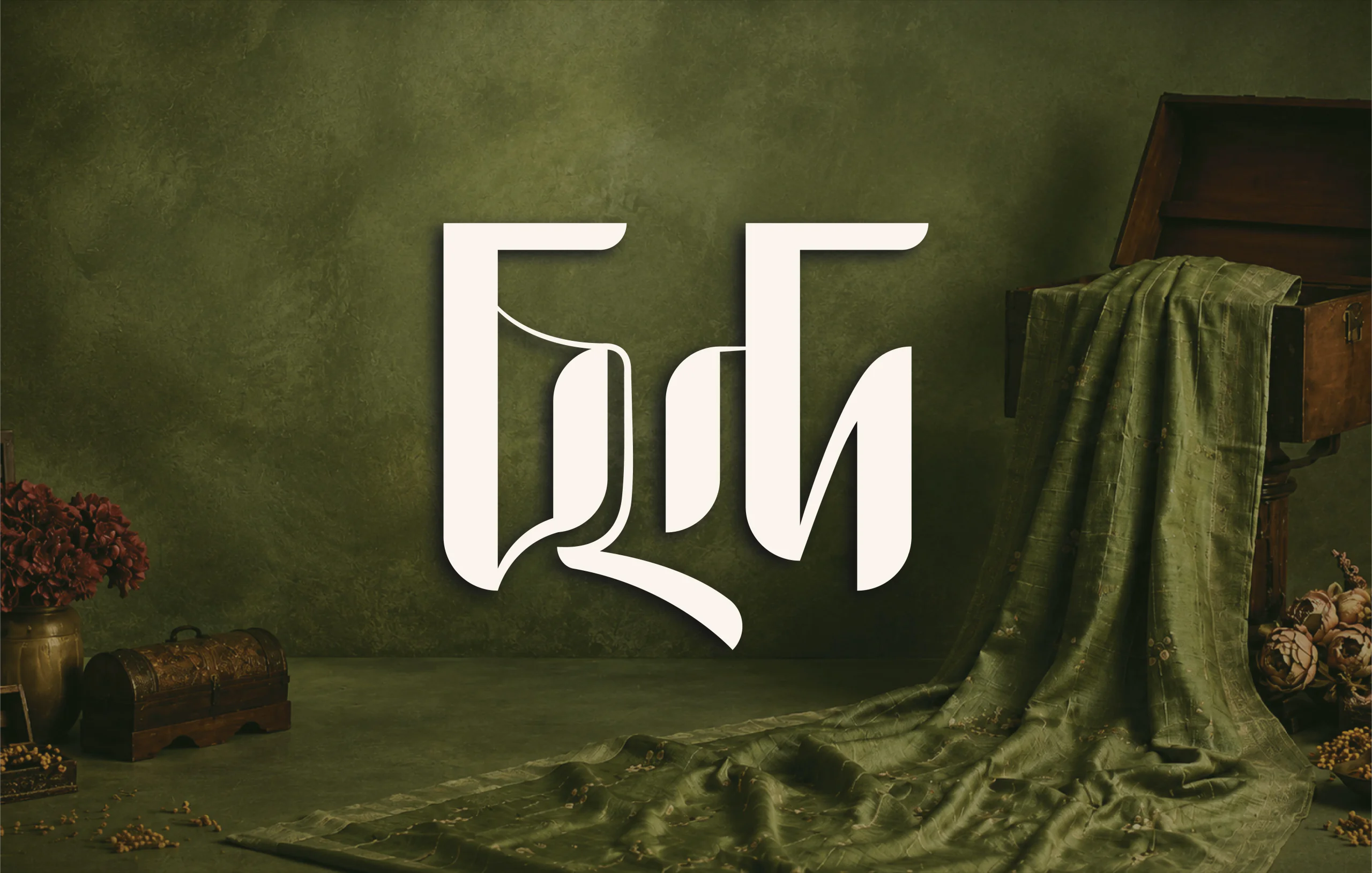 Chhondo Bangla typographic logo on an olive green set with draped fabric